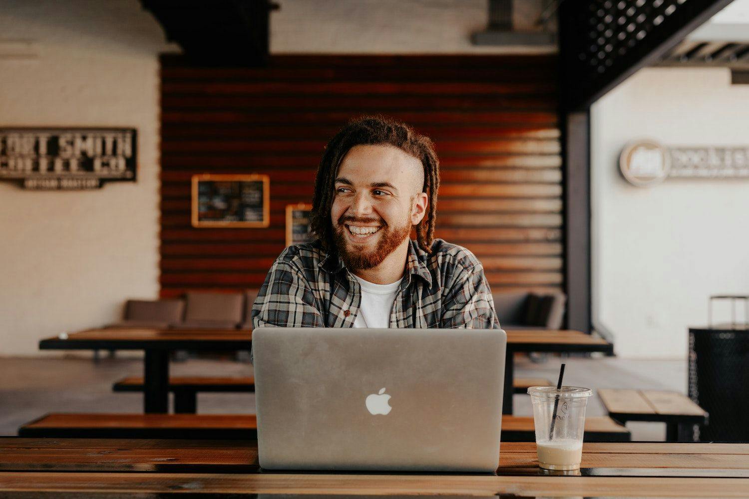 Man smiling working on laptop