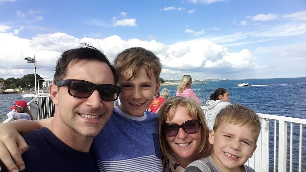 This is photo of Debra and her family by the sea
