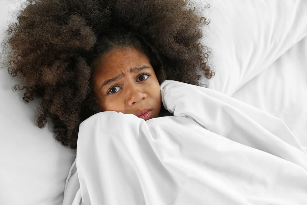 Scared child in bed