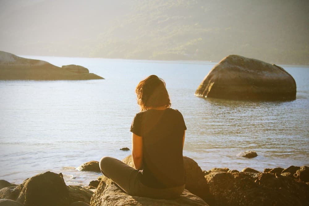 woman sat on rock