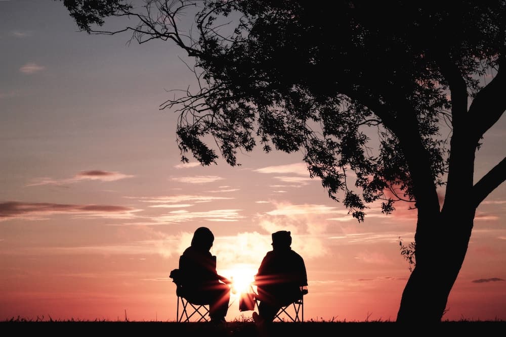 people sitting together on hill