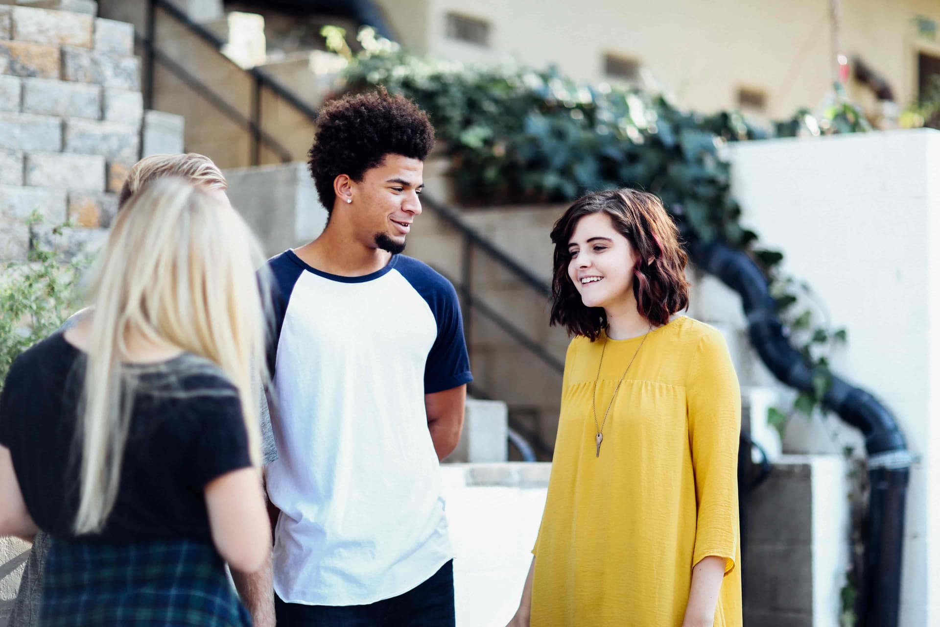 teens-smile-and-chat-together-outside