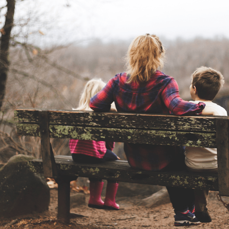 Parent-shares-advice-with-two-children-on-bench