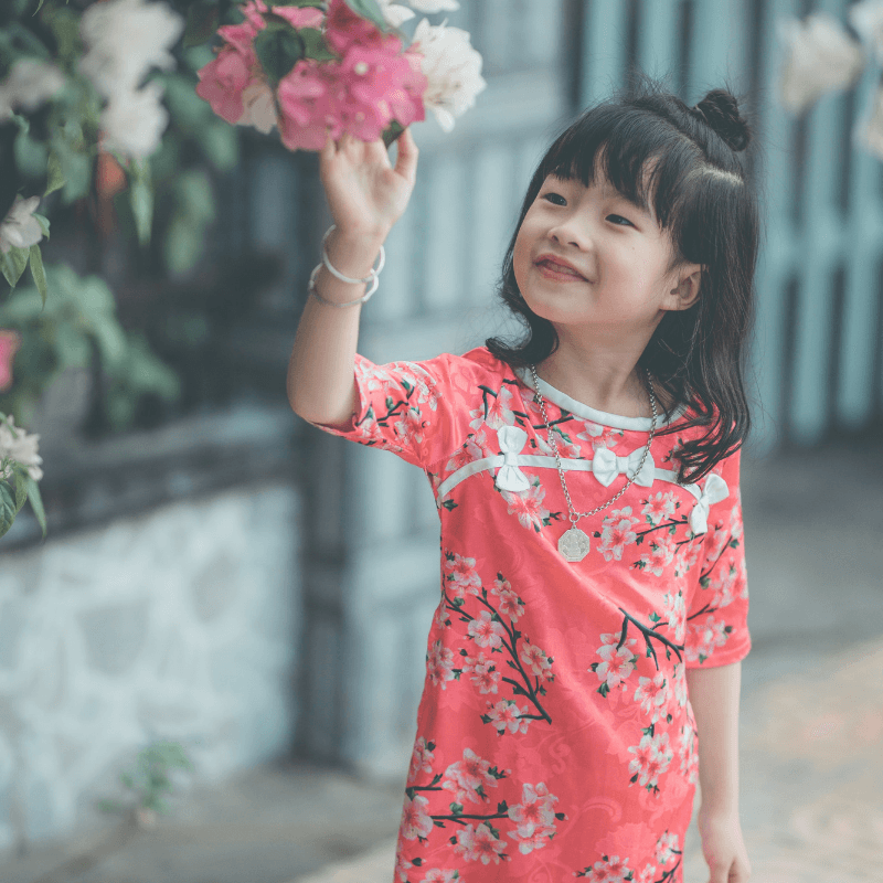 Young-girl-curiously-looks-at-flowers