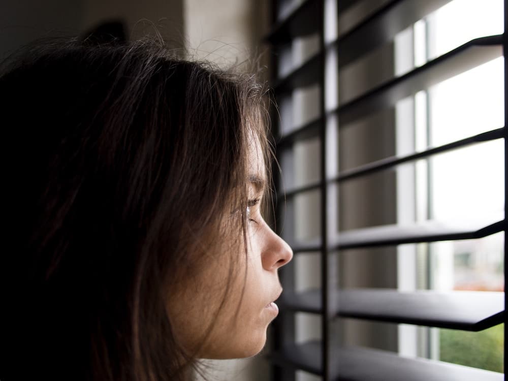 woman looking out window