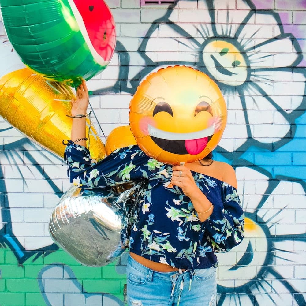 woman holding baloons