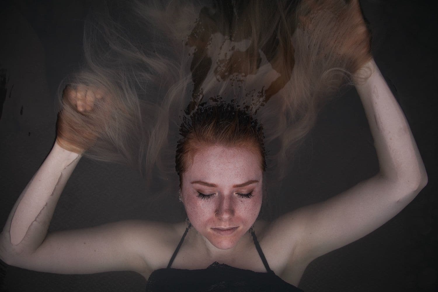 Person floating in water.