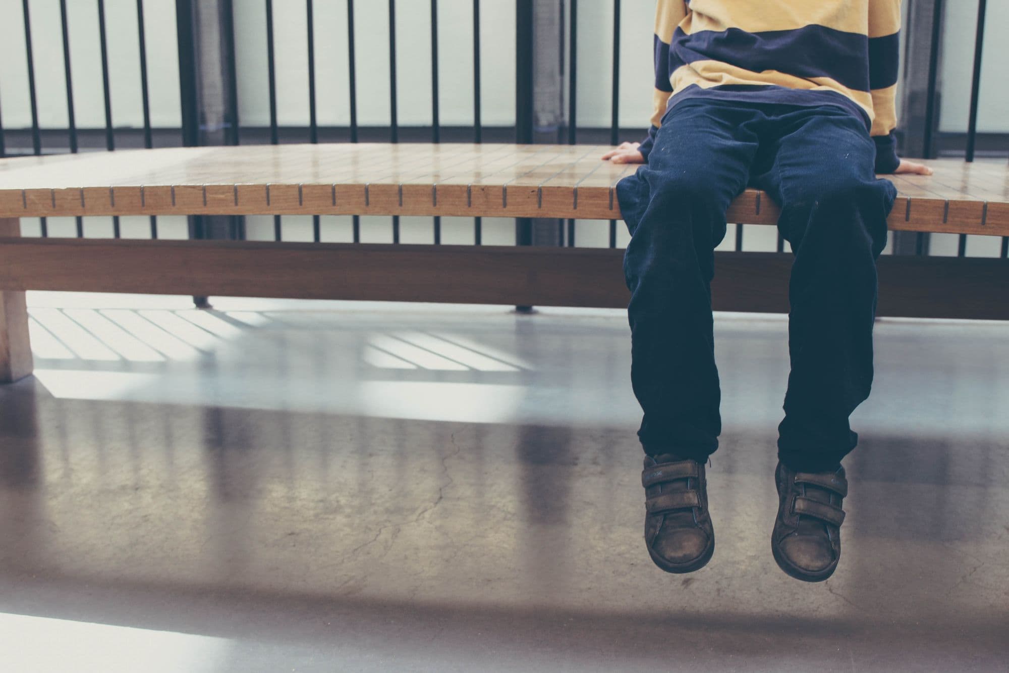 Child sits on a bench