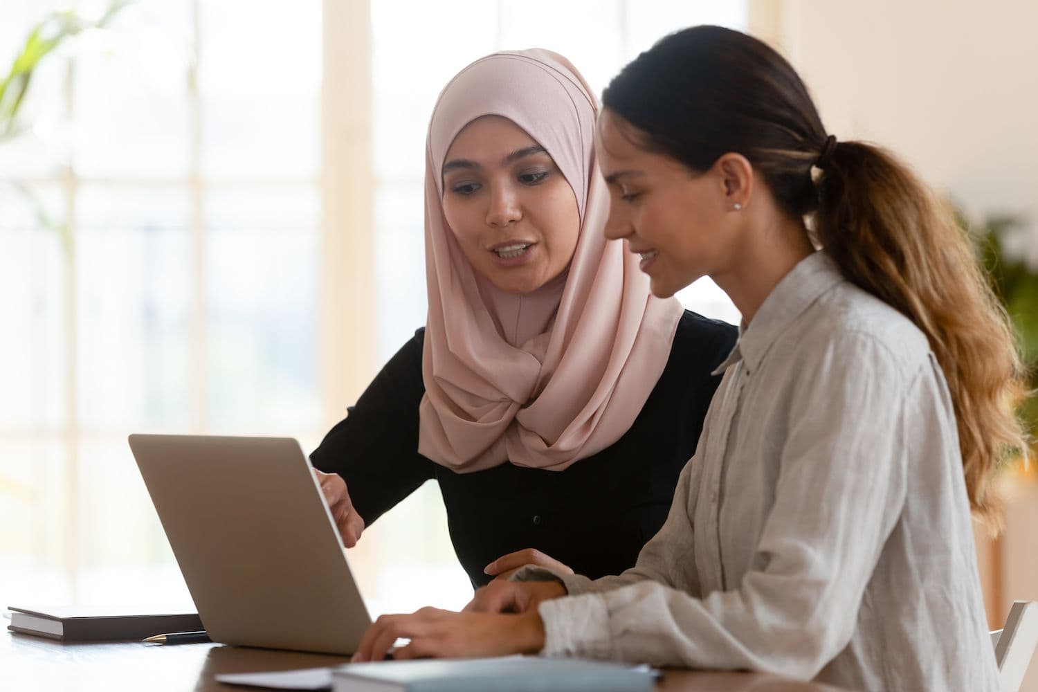 Two people looking at laptop.