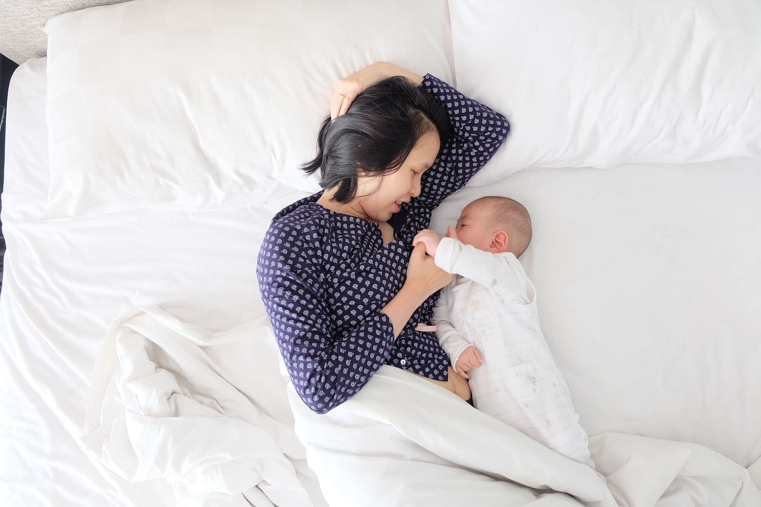 Mother and baby in bed.