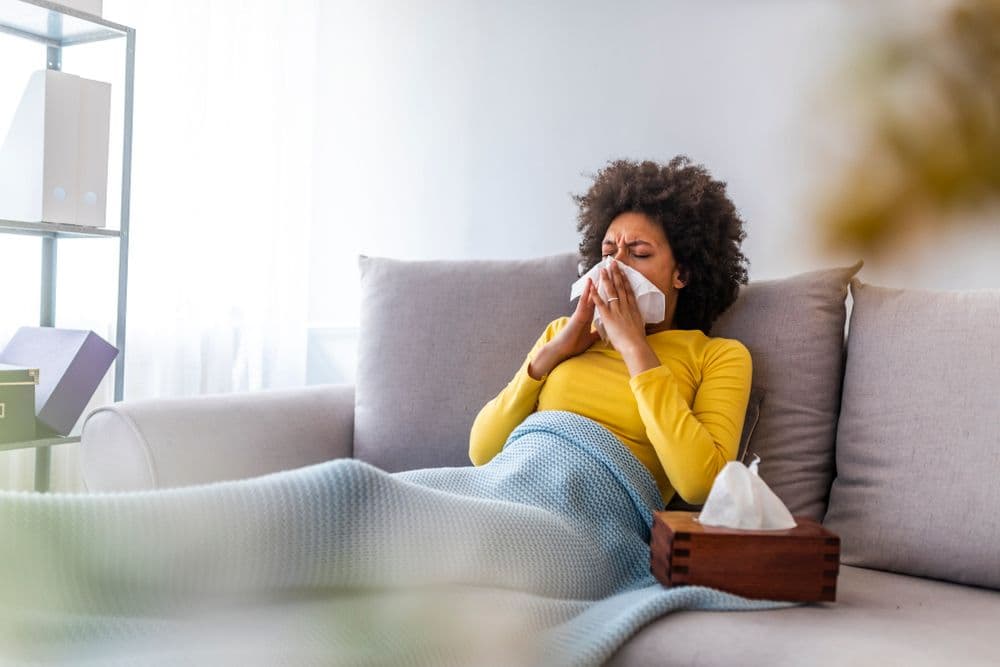 Woman blowing her nose