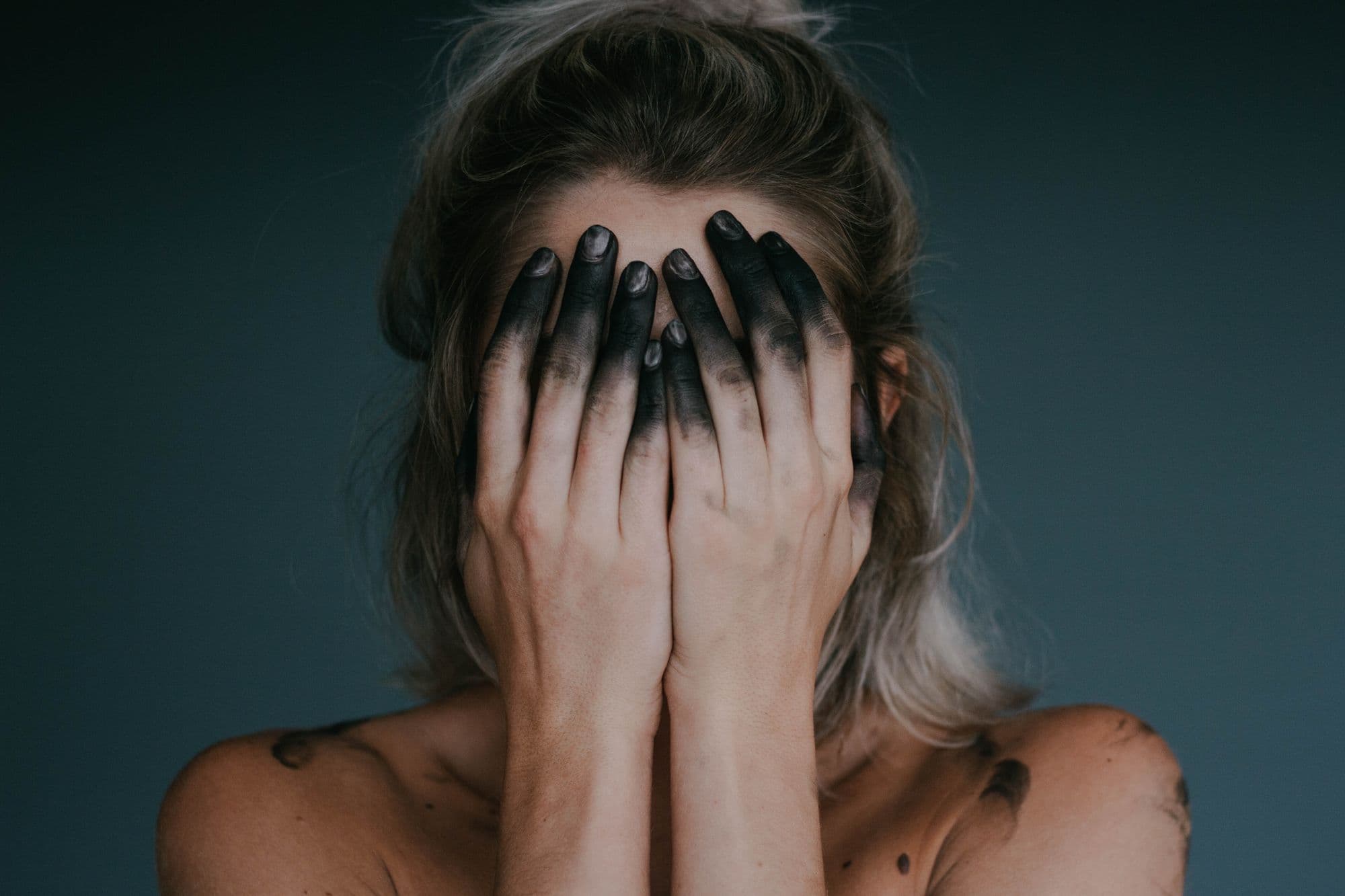 Woman with hands over face