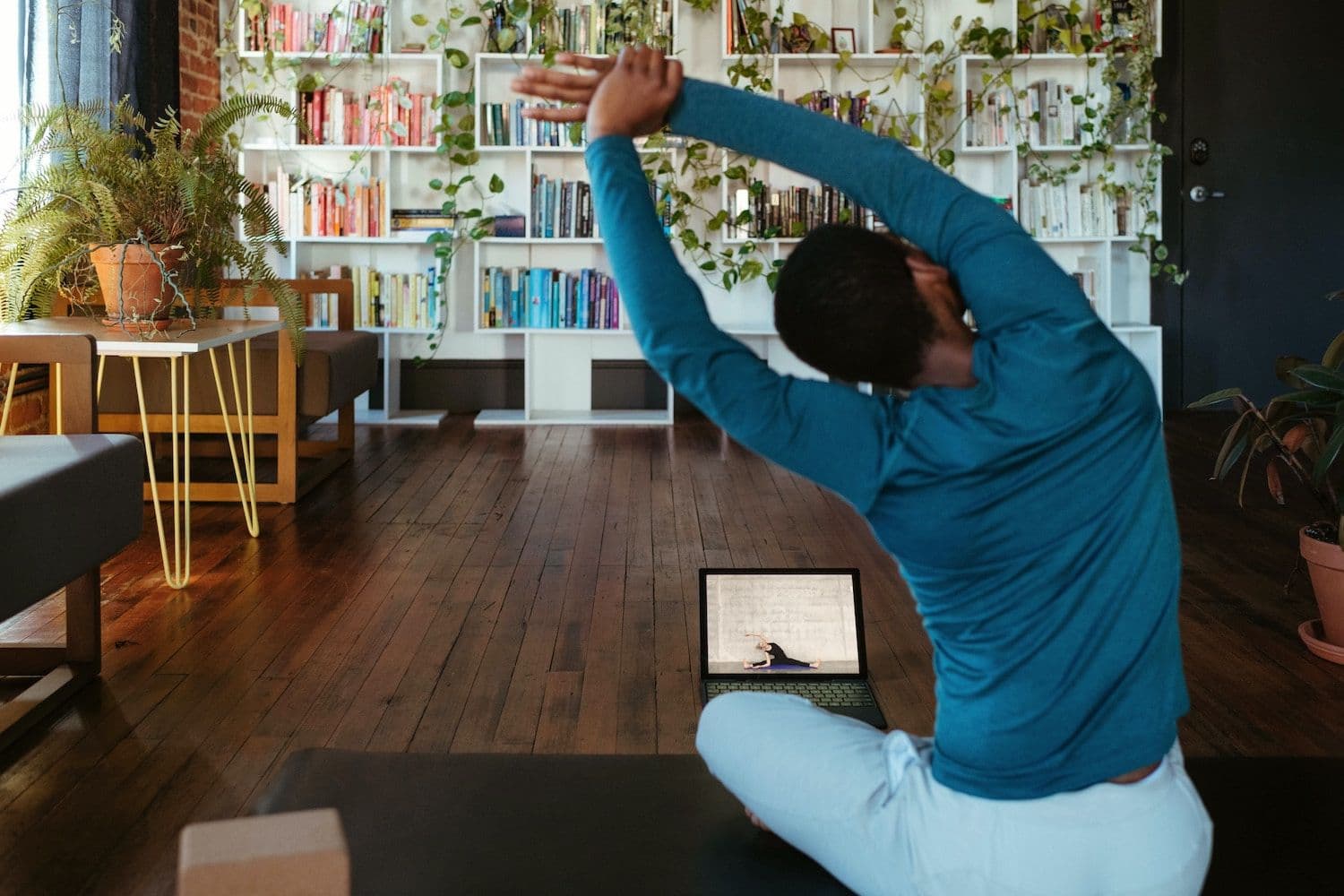 Image shows a person stretching with their back to the camera.