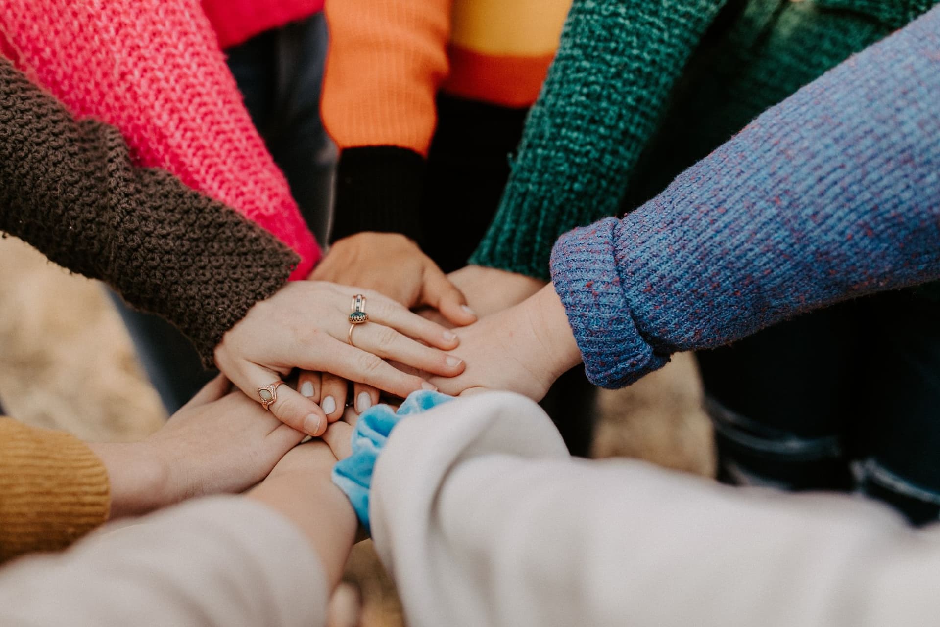 Group of women with their hands on top of each other
