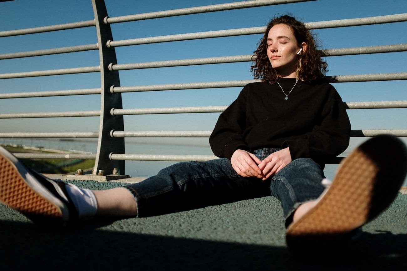 Woman listening to podcast with eyes closed