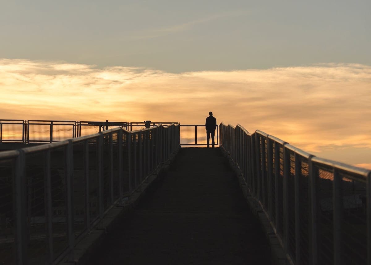 Person stood looking out at sunset.