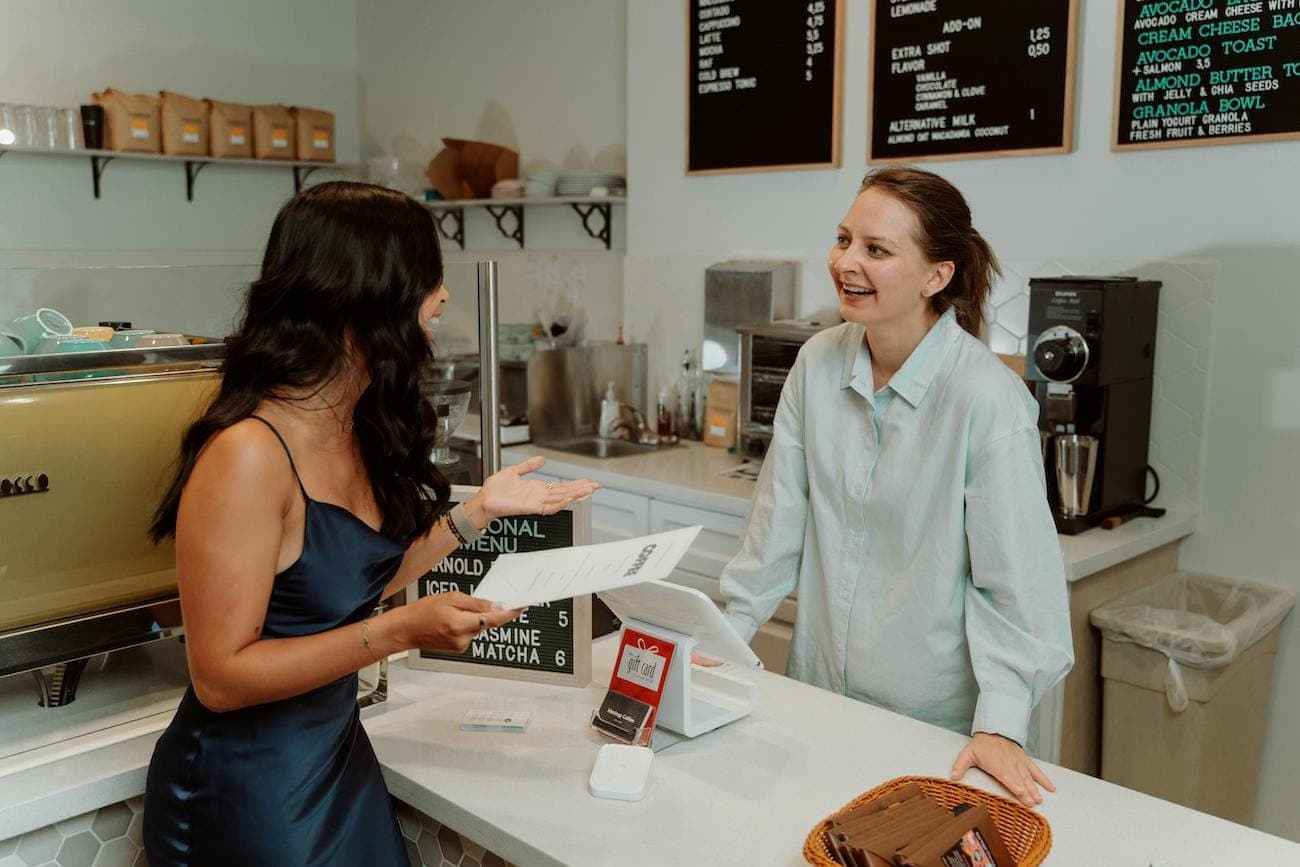 Person talking to cafe owner
